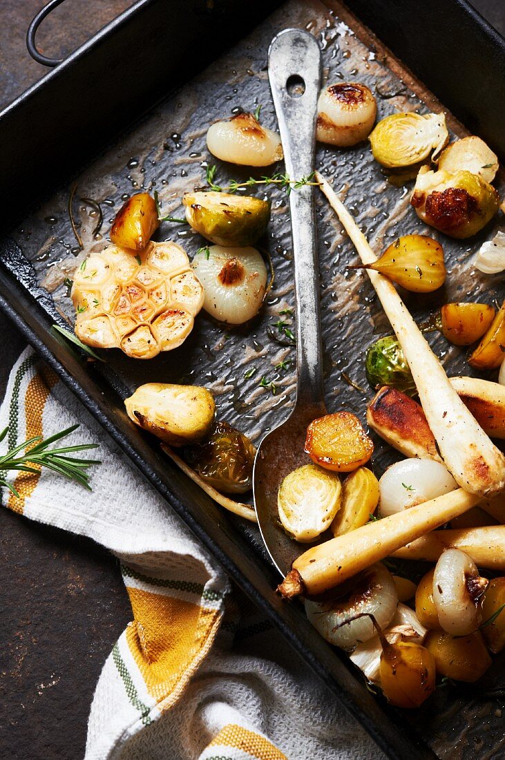 Assorted Vegetables Roasted in Duck Fat with Herbs, Sea Salt and Black Pepper; On Pan with Serving Spoon