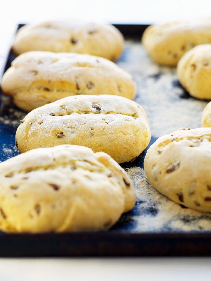 Cheese rolls with olives on a baking tray