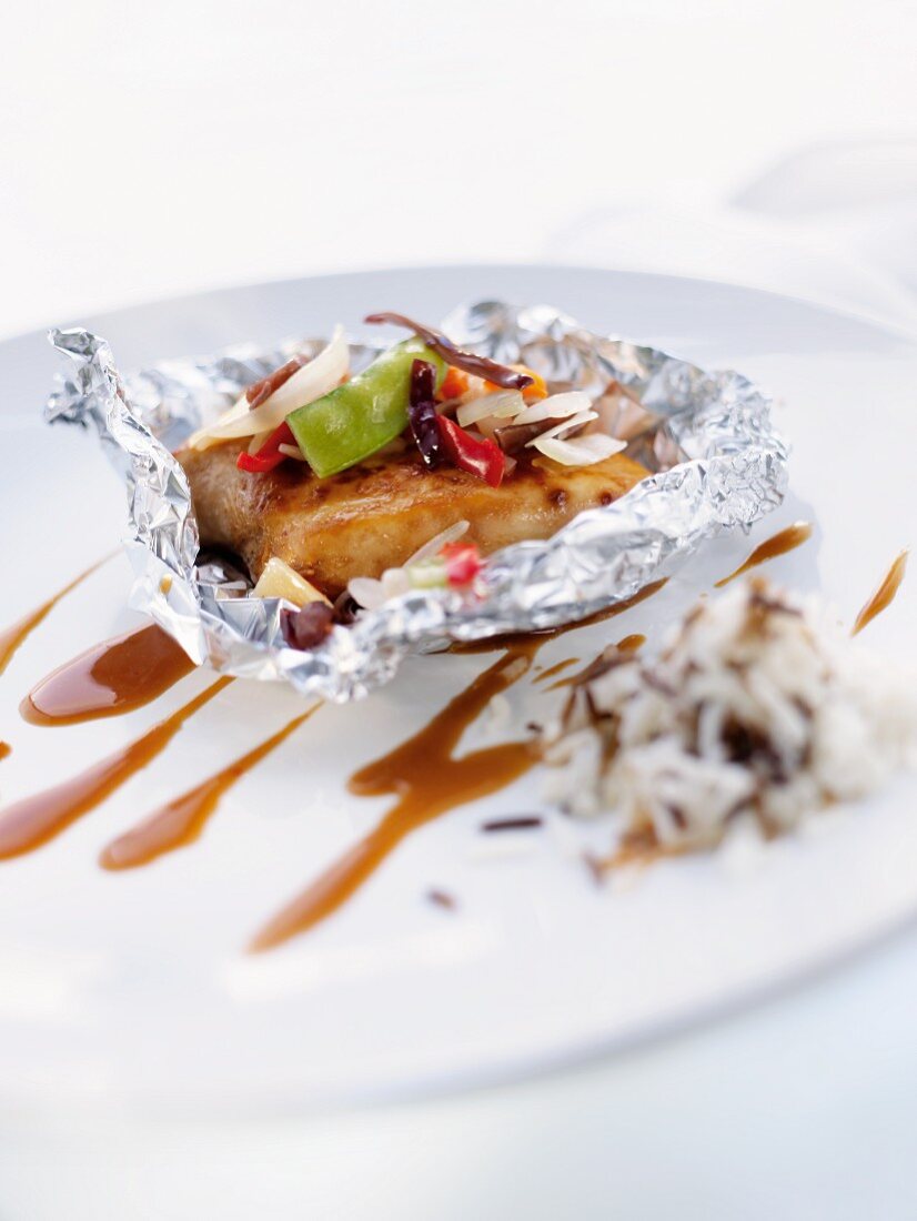 Chicken with vegetables wrapped in aluminium foil