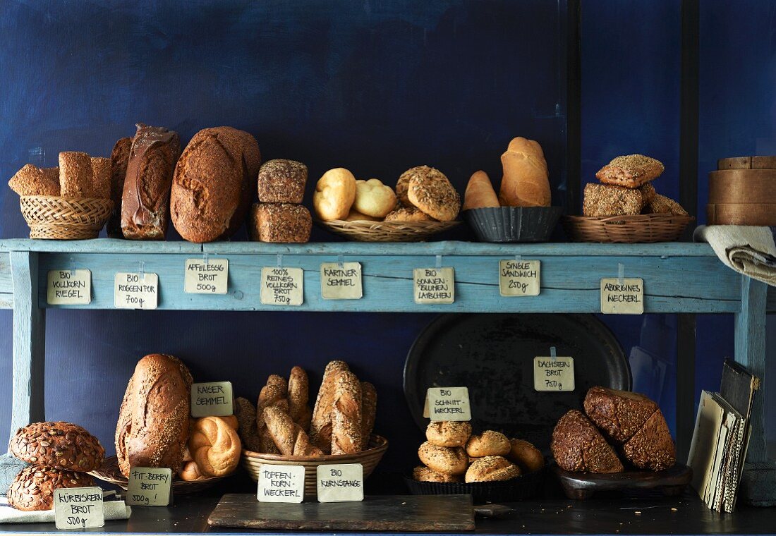 Various bread and bread rolls on a kitchen shelf