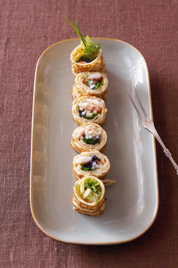 Pancake rolls with surimi and caviar