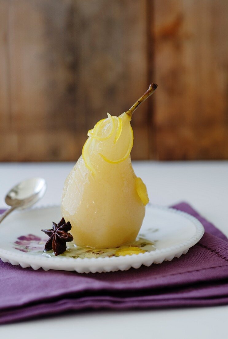 A poached pear with lemon, ginger and star anise