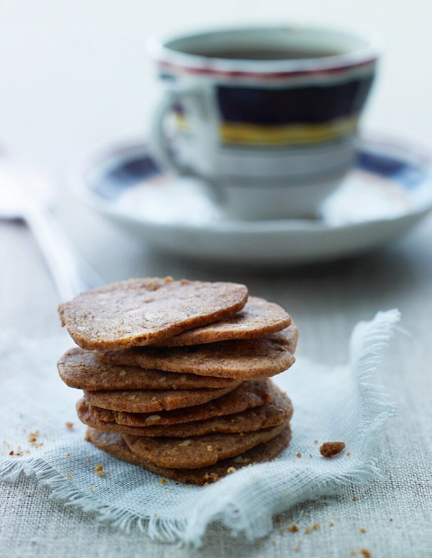 A stack of nut biscuits and a cup of tea