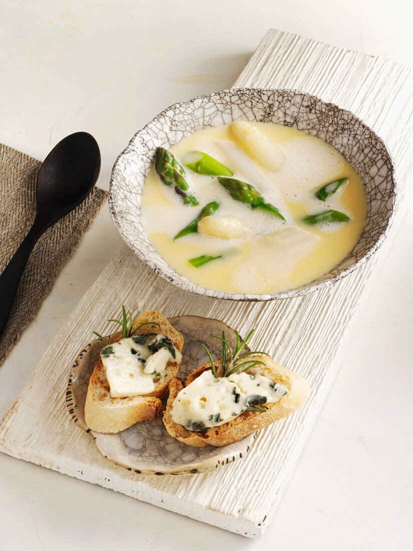 Cream of asparagus soup served with a cheese baguette
