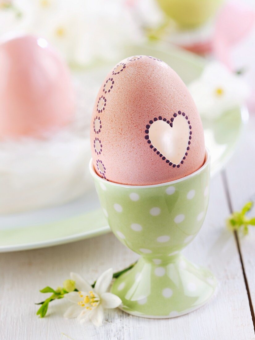 Osterei mit Herzdeko in Eierbecher