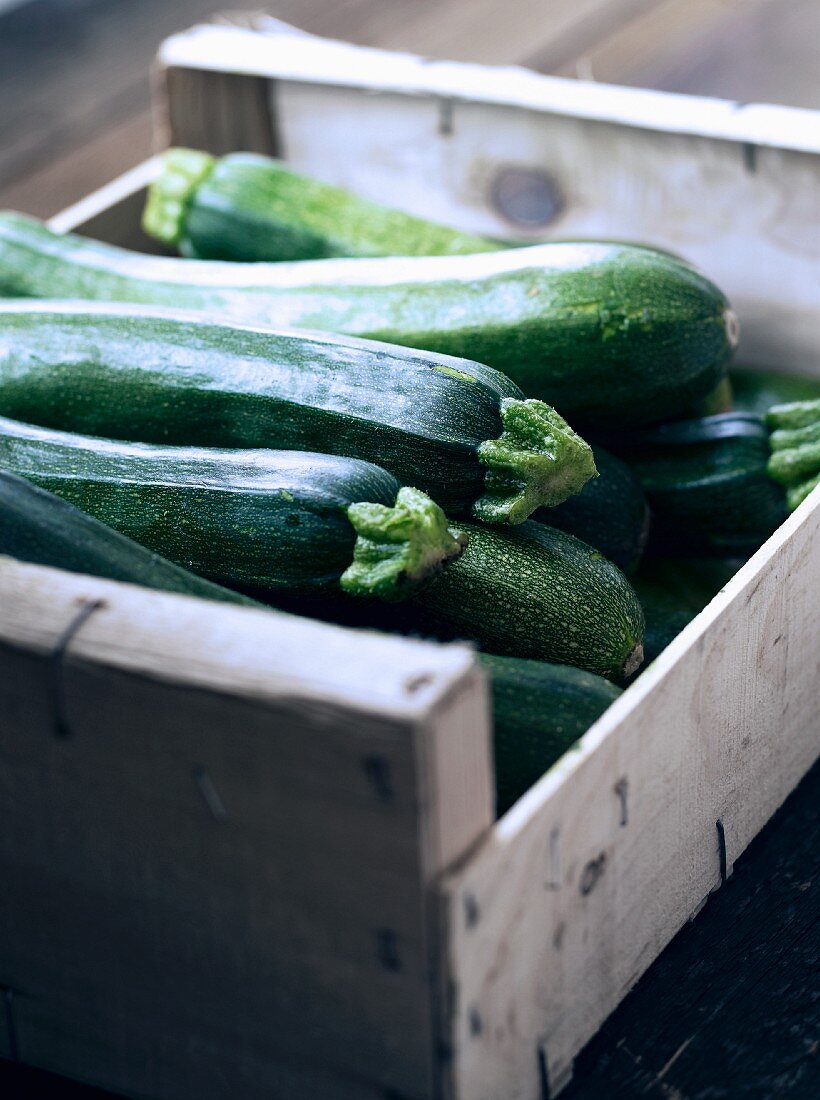 Courgettes in a wooden crate