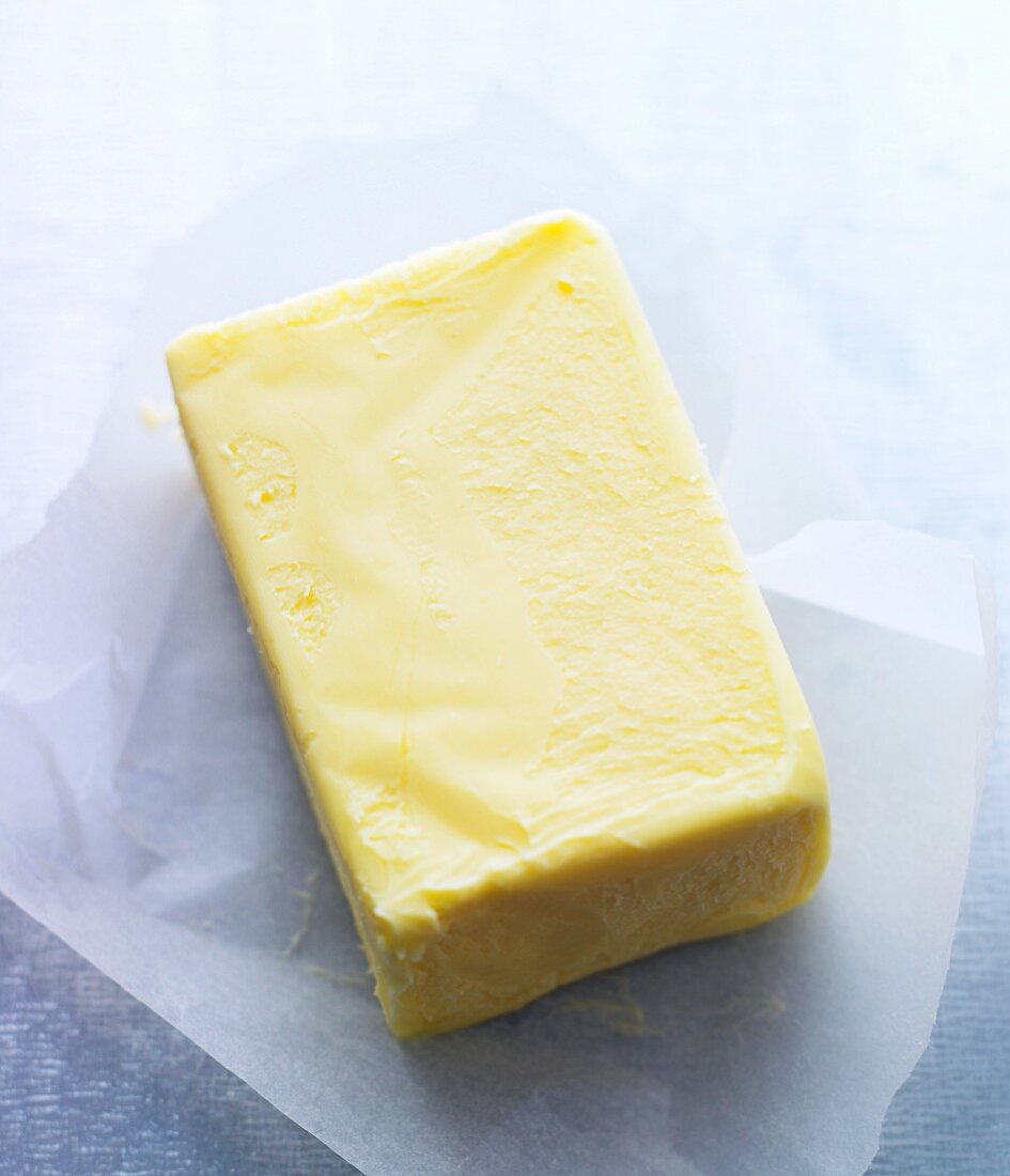 A pat of butter on a piece of parchment paper