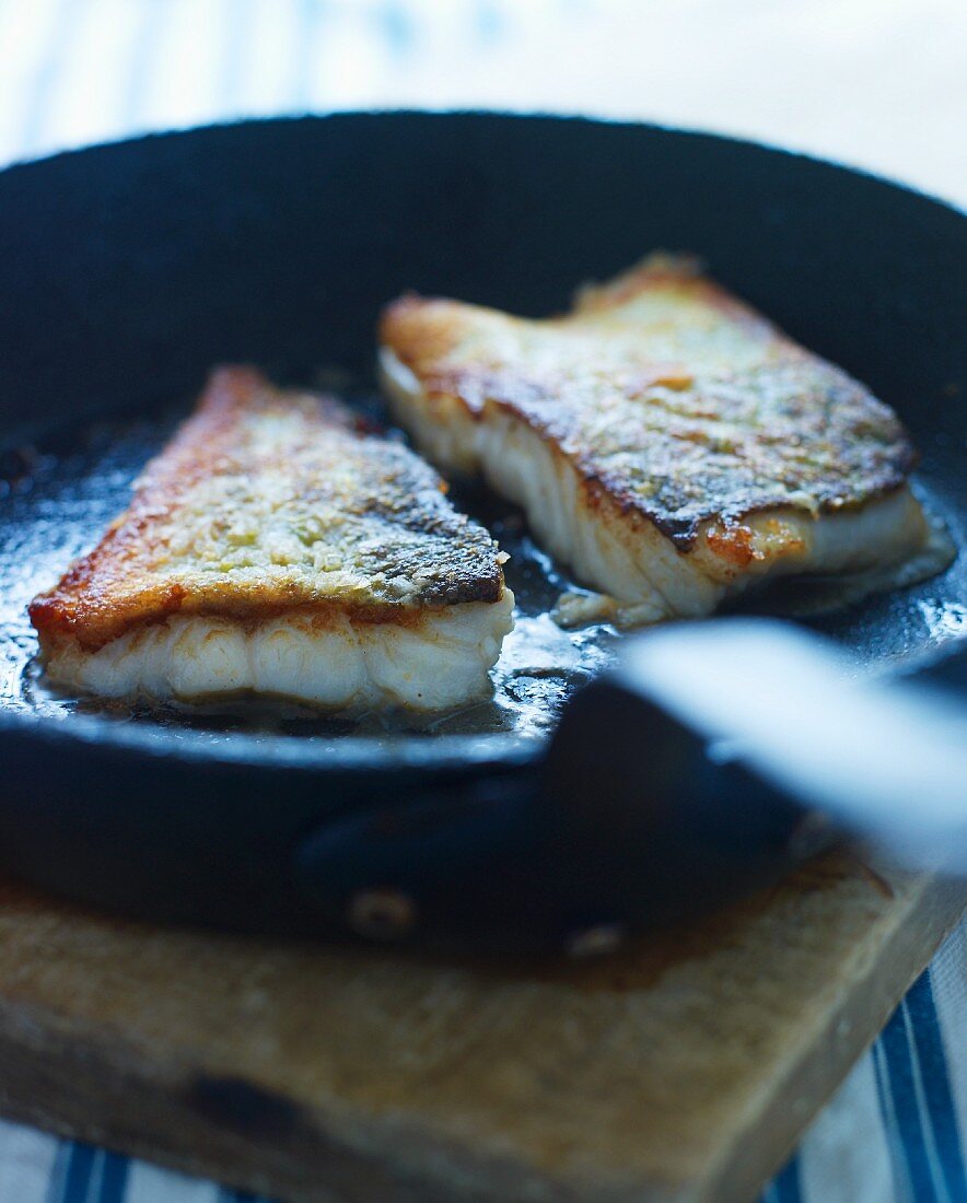 Fried fish fillets in a pan