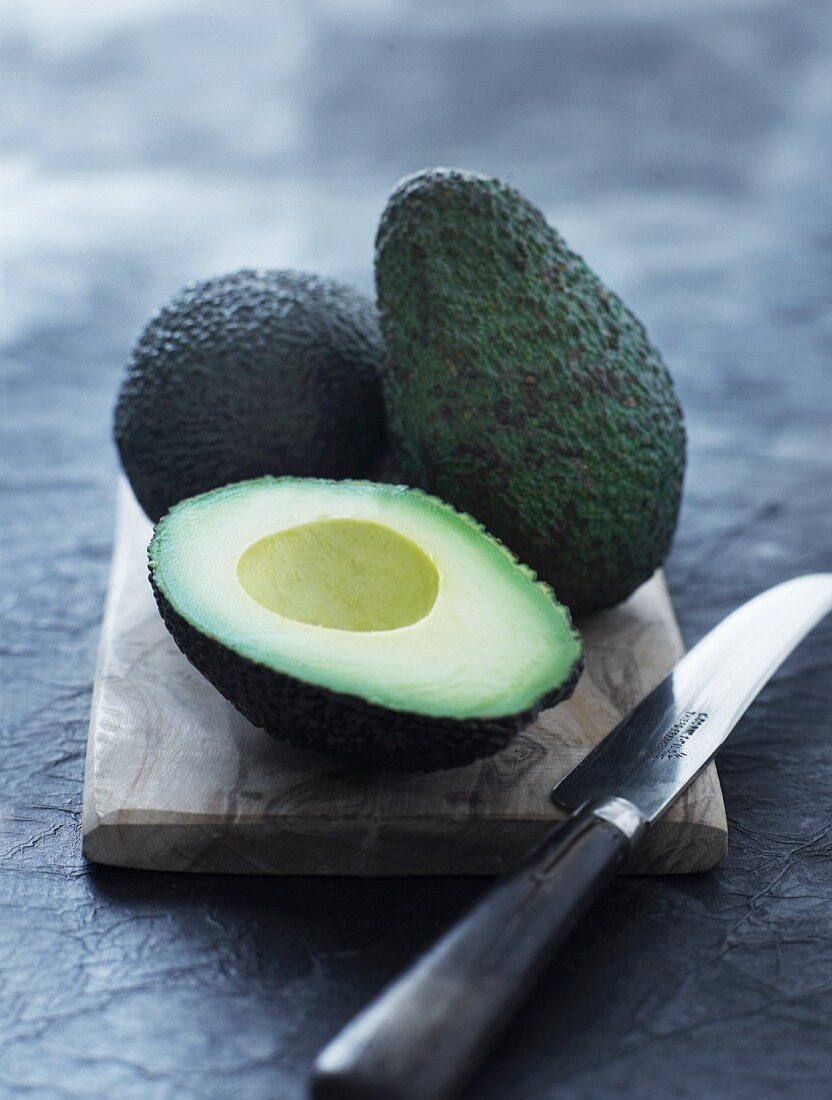 Avocados, whole and halved