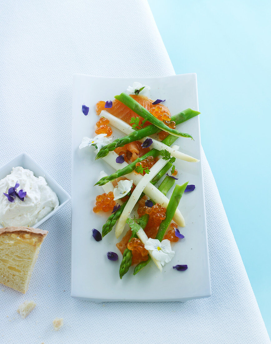 Asparagus with salmon, caviar, edible flowers and quark dip