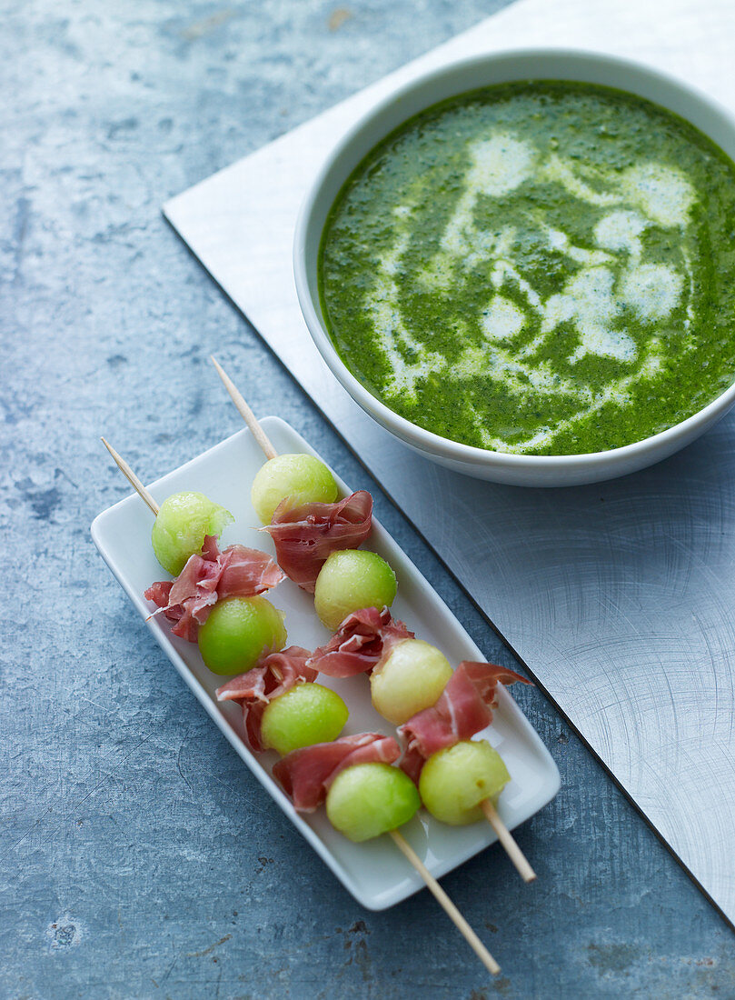 Herb soup and melon and ham kebabs