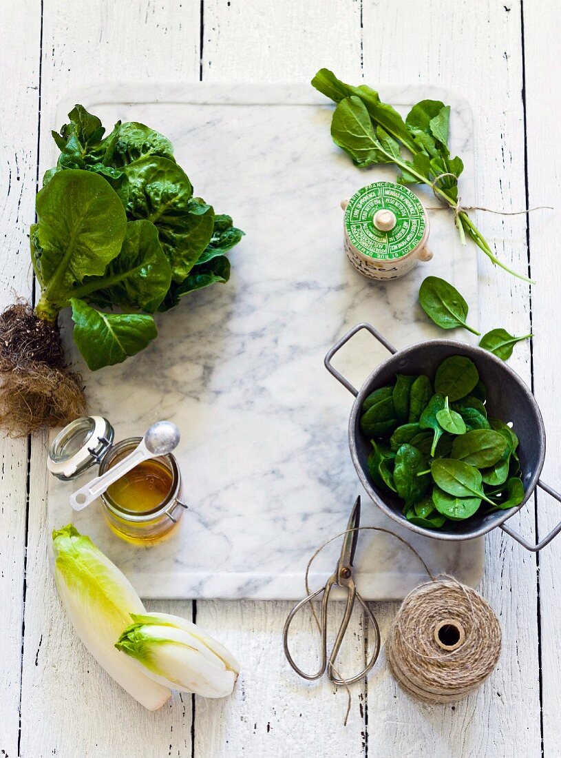Various types of lettuce, kitchen twine and honey