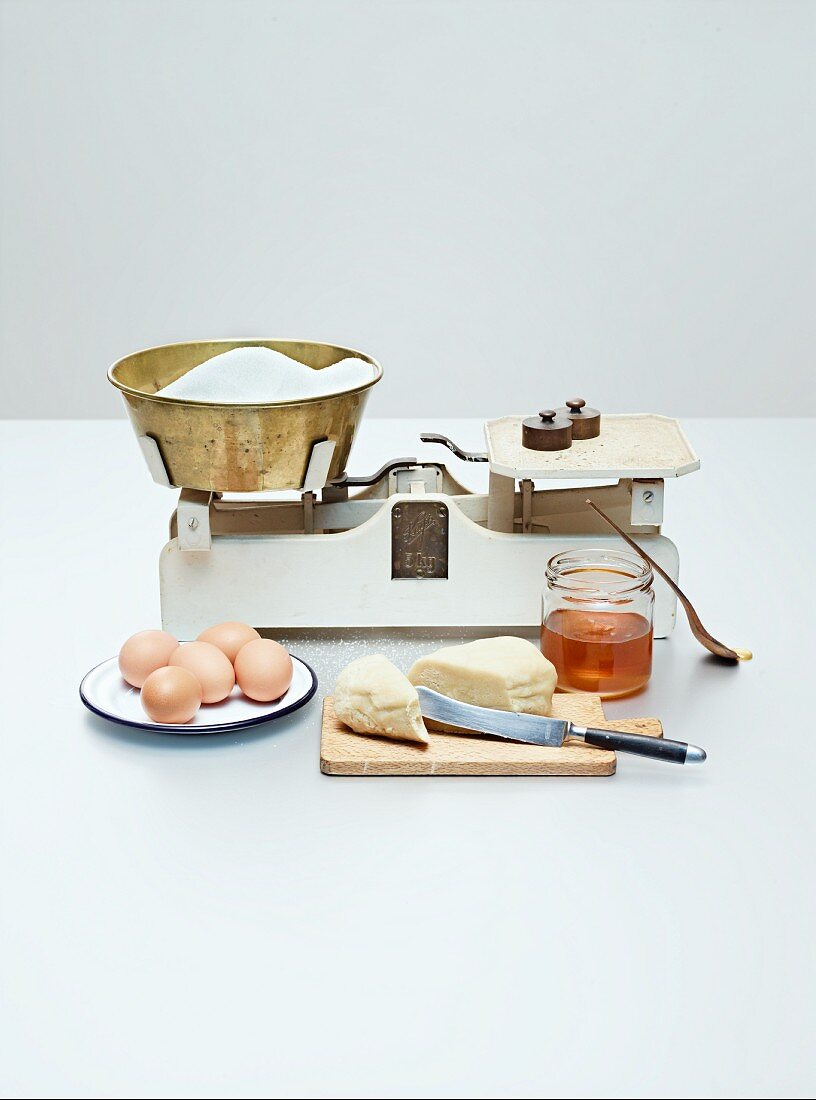 Ingredients for gingerbread biscuits (eggs, sugar, honey, marzipan)