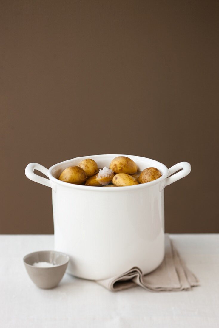 Unpeeled potatoes in a pot of salt water