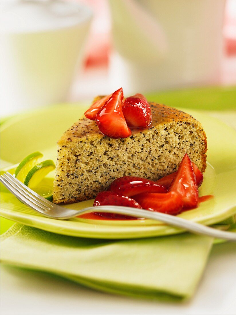 A slice of poppyseed cake with strawberries