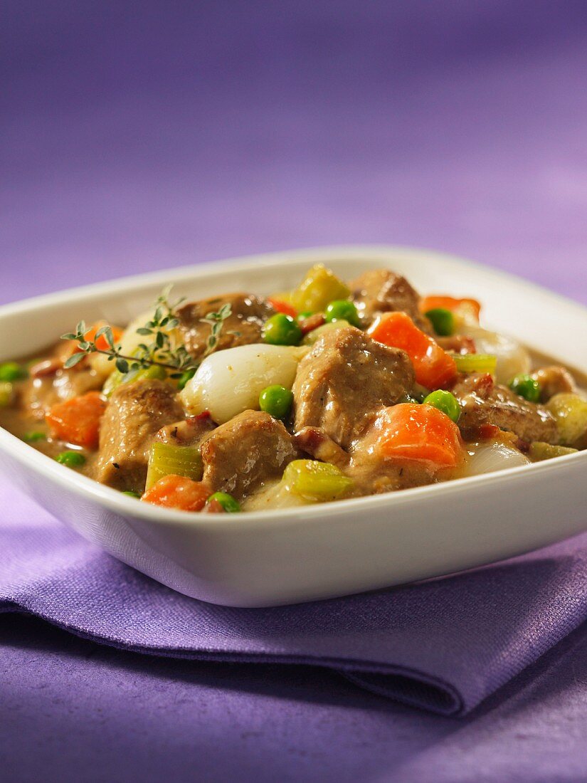 Braised veal ragout with carrots and peas