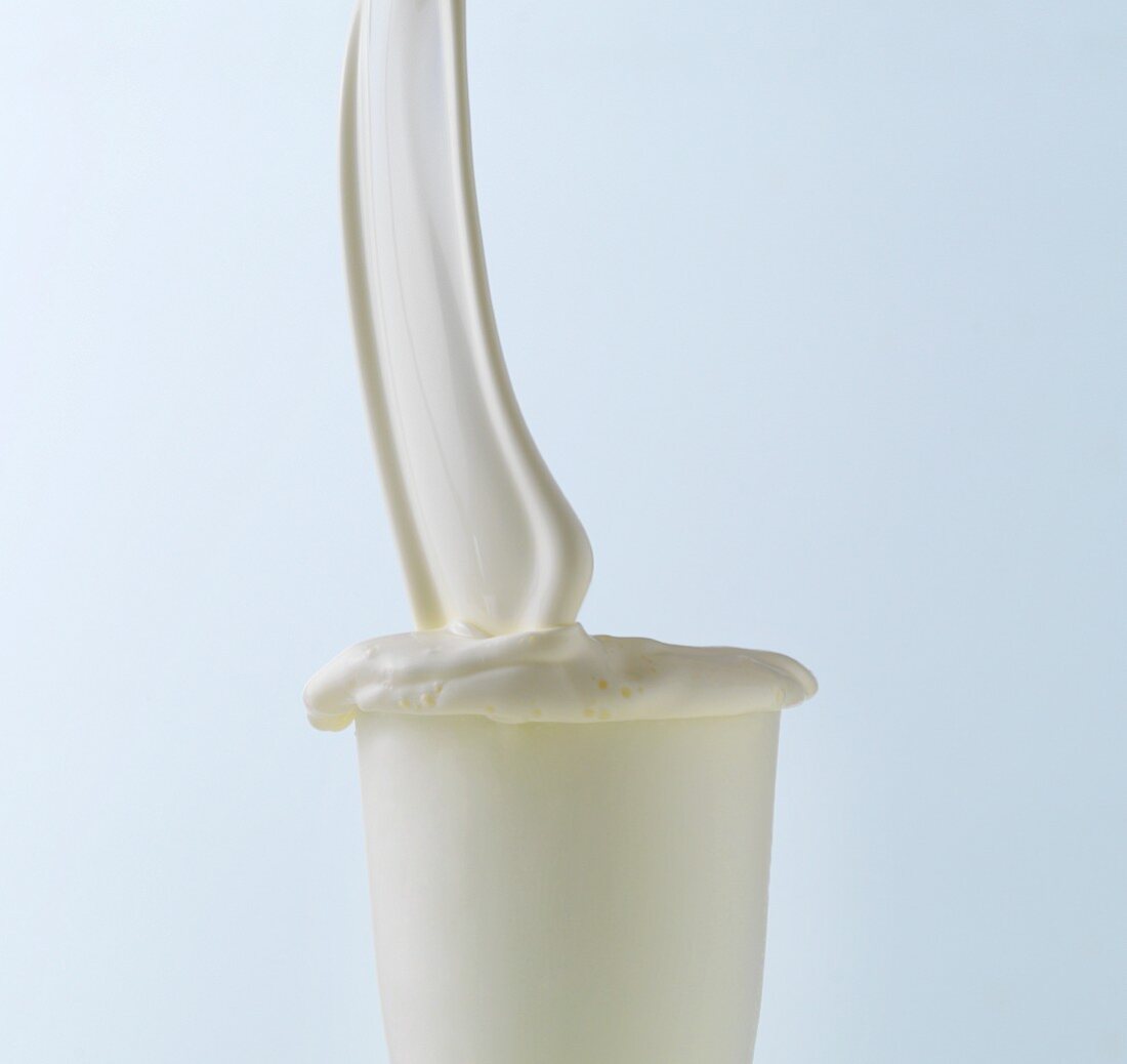 Cream being poured into a glass