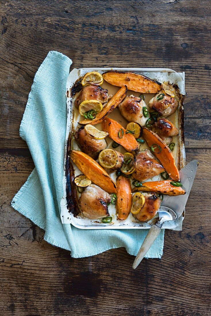 Oven-baked chicken with sweet potatoes and lemon slices