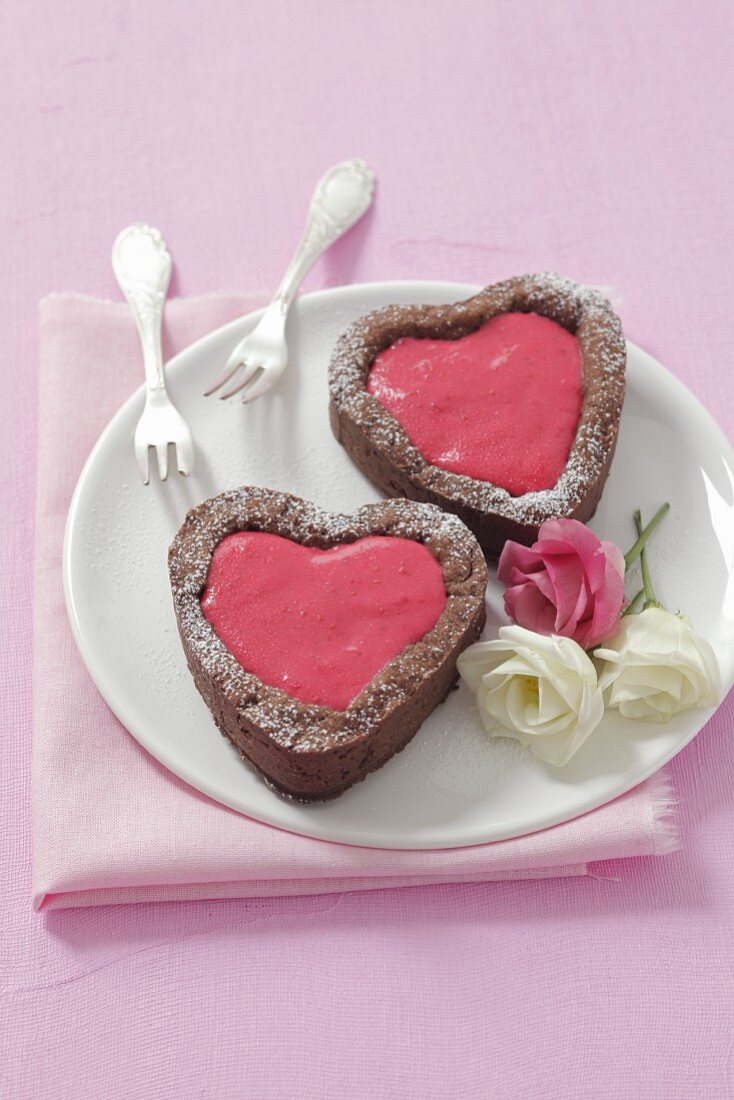 Heart-shaped chocolate cakes with raspberry mousse
