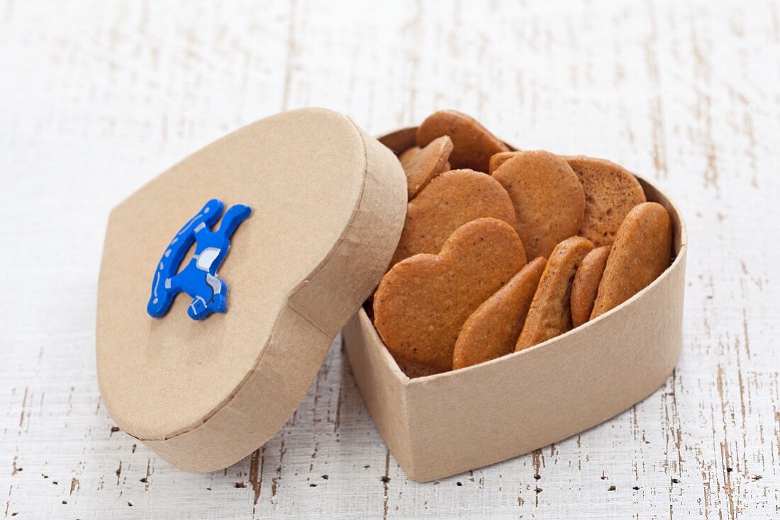 Heart-shaped gingerbread biscuits in a heart-shaped tin