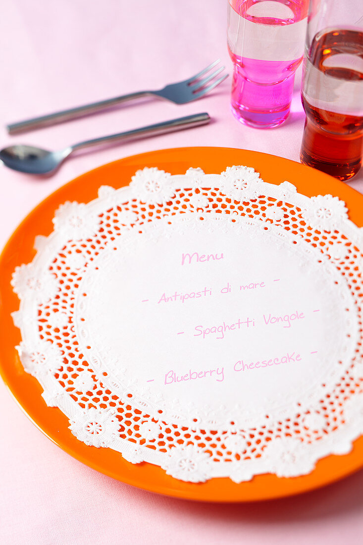 A doily used as a menu on a plate