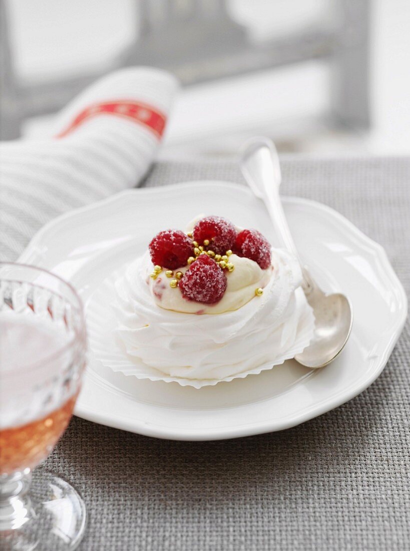 A meringue with cream and raspberries
