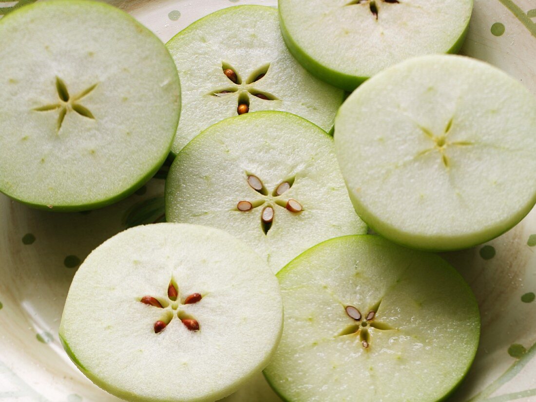 Slices of Green Apples with Seed Patterns