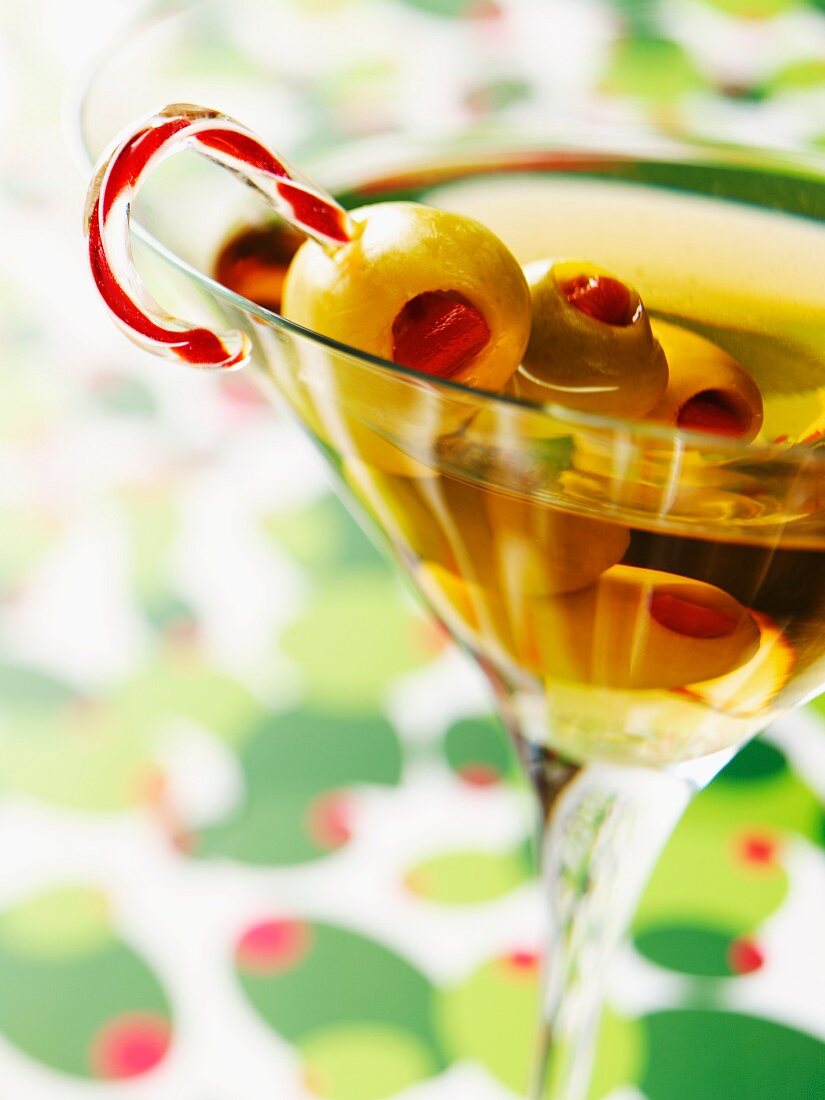Martini with Olives Skewered on a Candy Cane Swizzle Stick