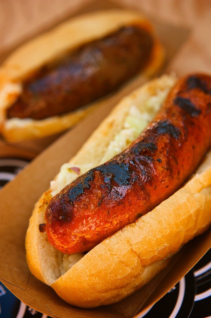 Seoul Company Sausage on a Bun in a Take Out Container