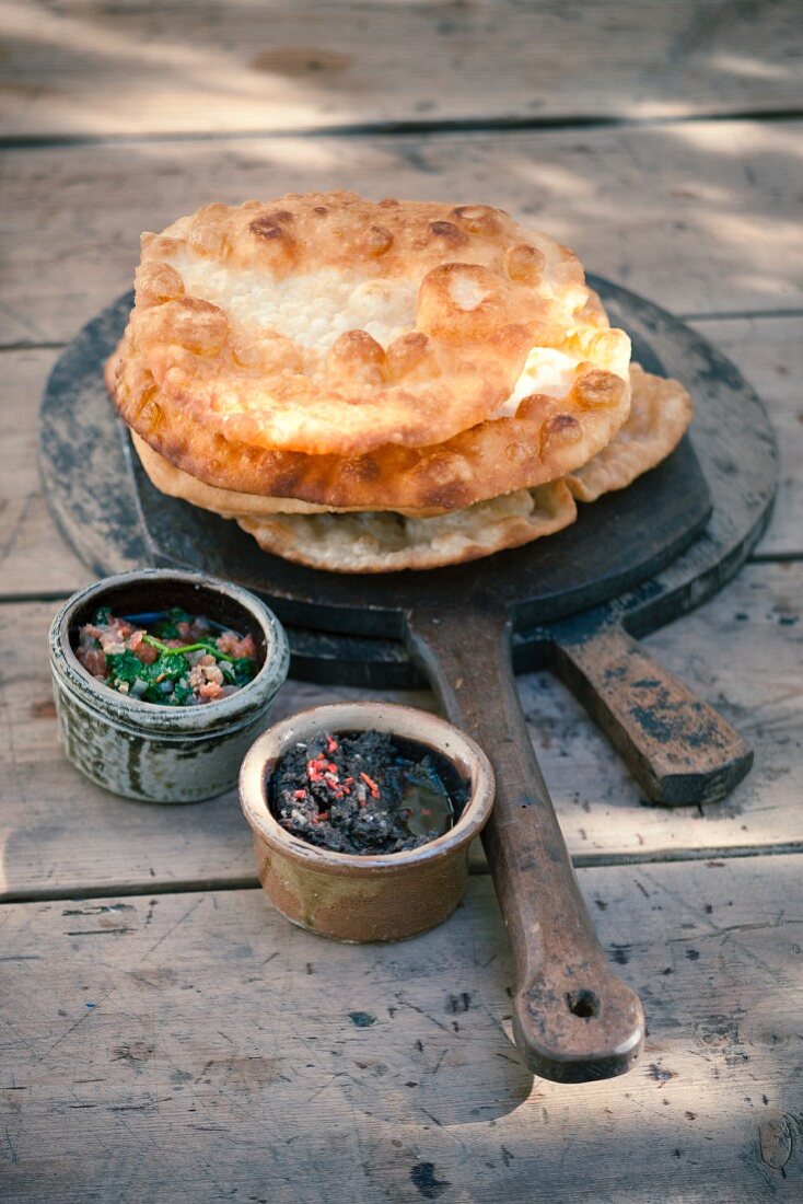 Crispy unleavened bread with tapenade and spinach paste