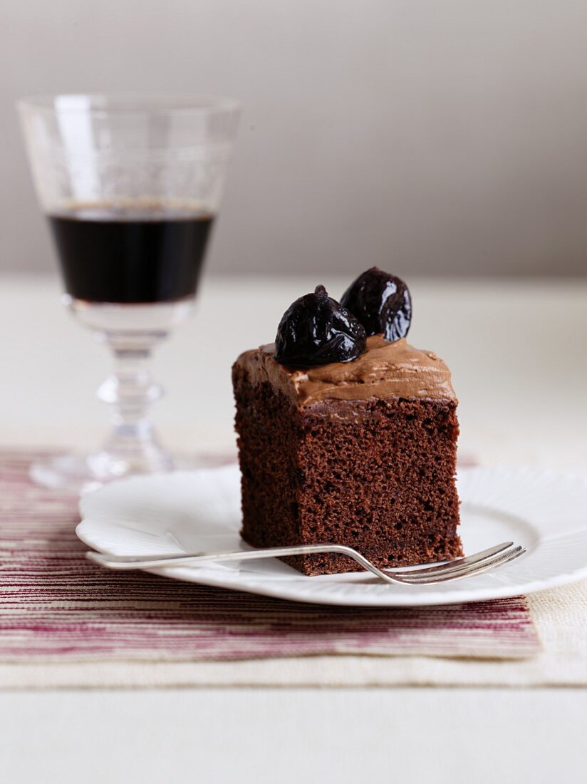 A slice of chocolate cake with prunes