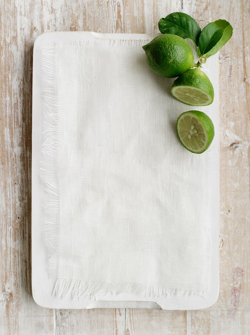 Limes on a chopping board