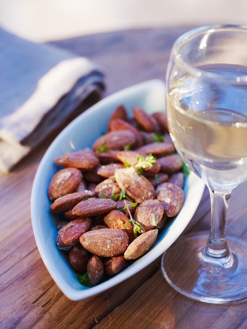Roasted almonds and a glass of white wine