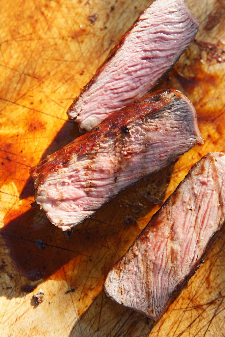 Sliced beef steak on a chopping board