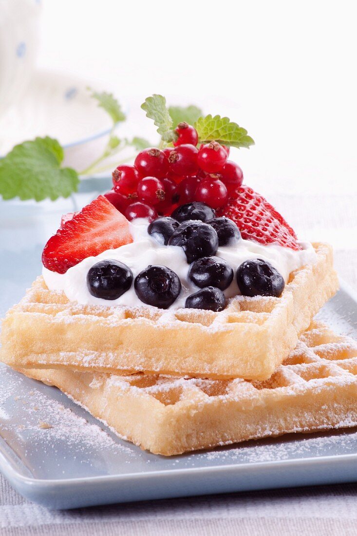 Waffles with Blueberries and Raspberries and Whipped Cream