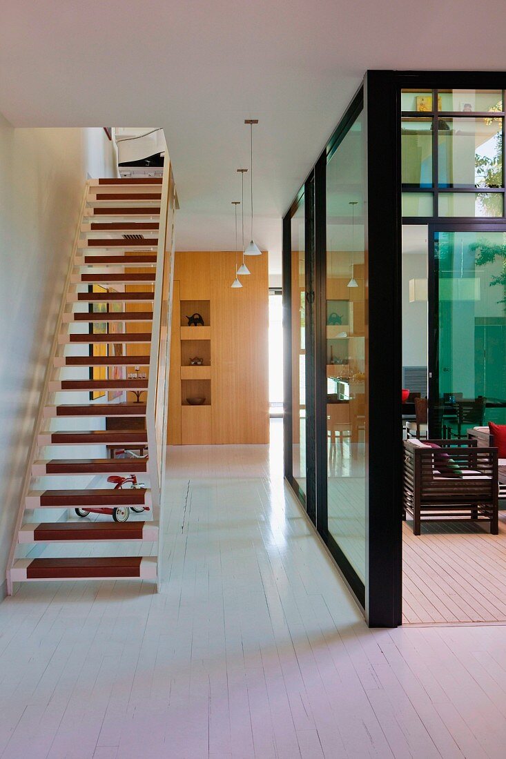 Staircase in open-plan foyer with view of glazed courtyard