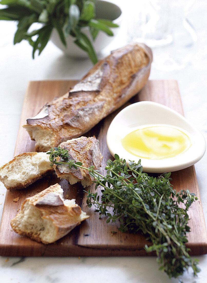 A baguette topped with olive oil and thyme