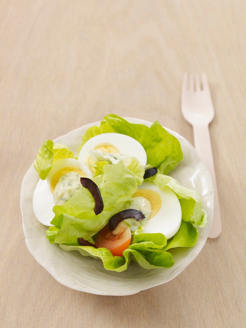 A salad with eggs and herb mayonnaise