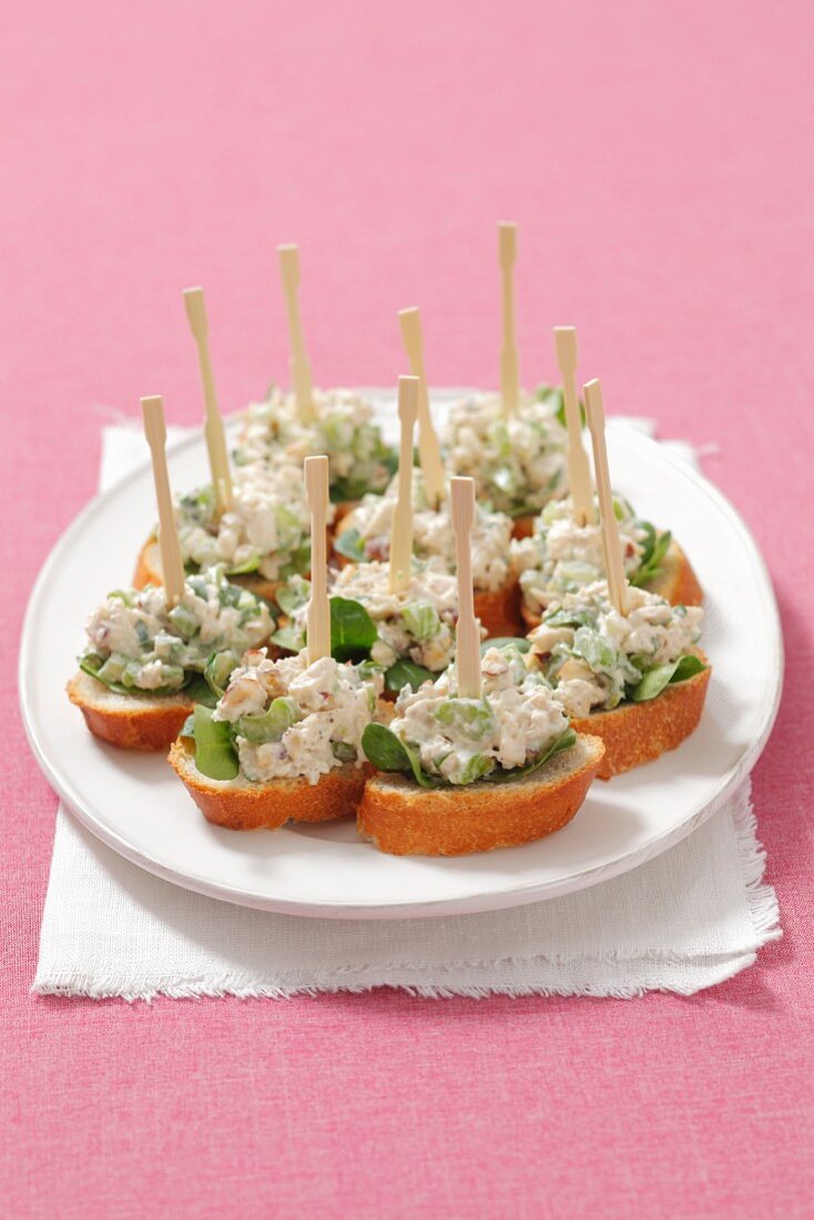 Crostini topped with a chicken and celery salad
