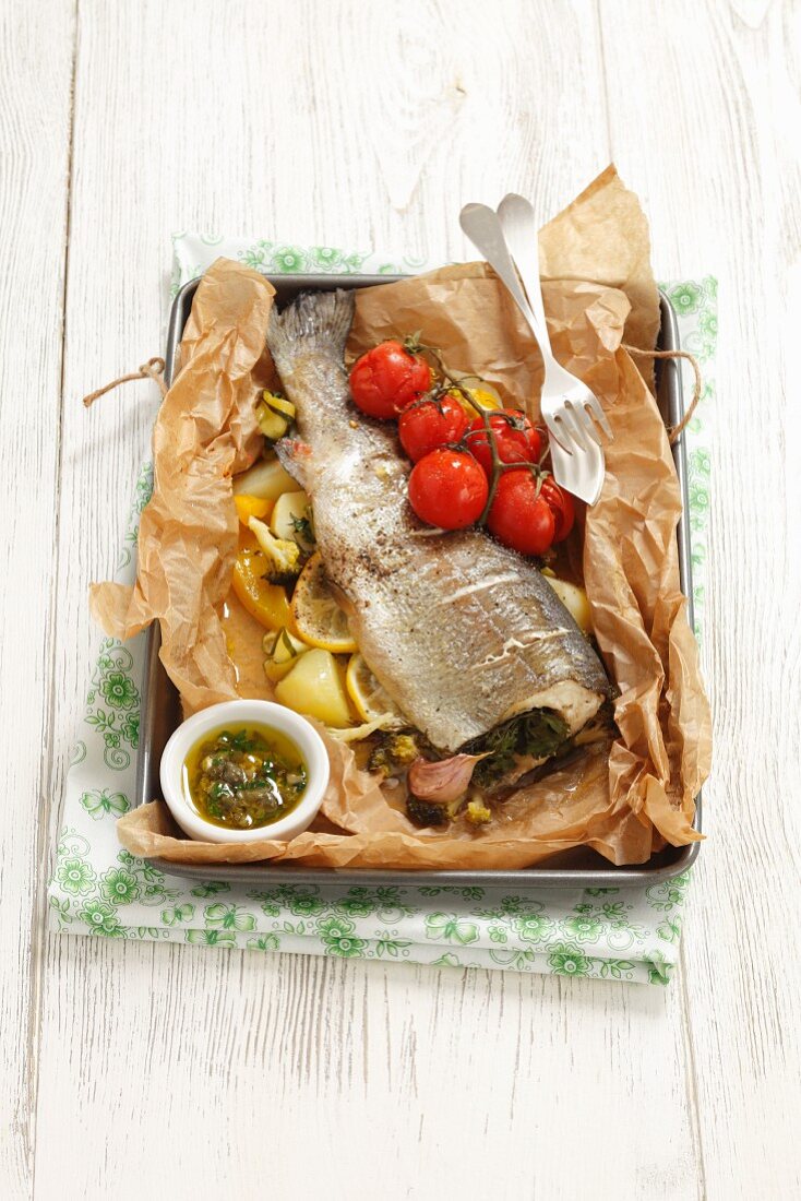 Trout with vegetables and caper sauce in foil