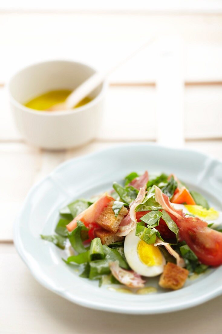 Sorrel salad with bacon, egg and croutons