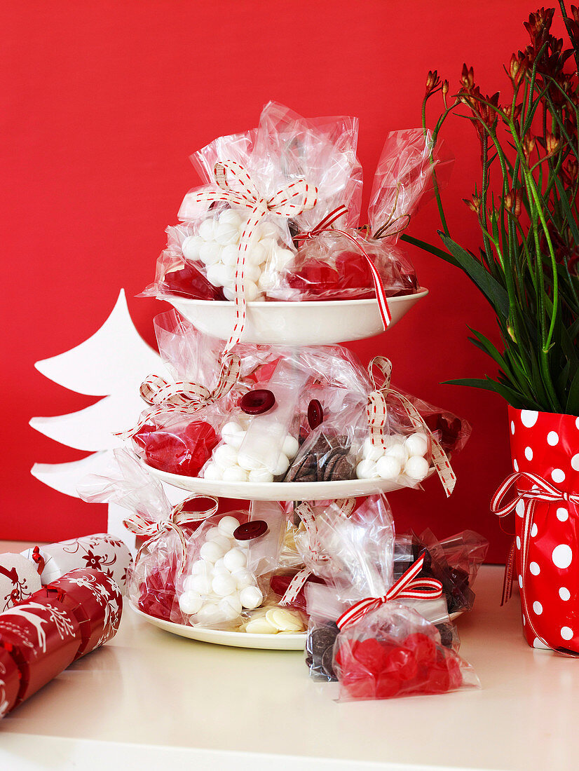 Christmas sweets in cellophane bags on a cake stand