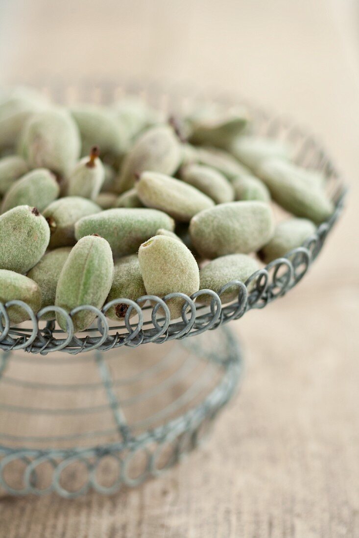 Fresh almonds in a wire basket