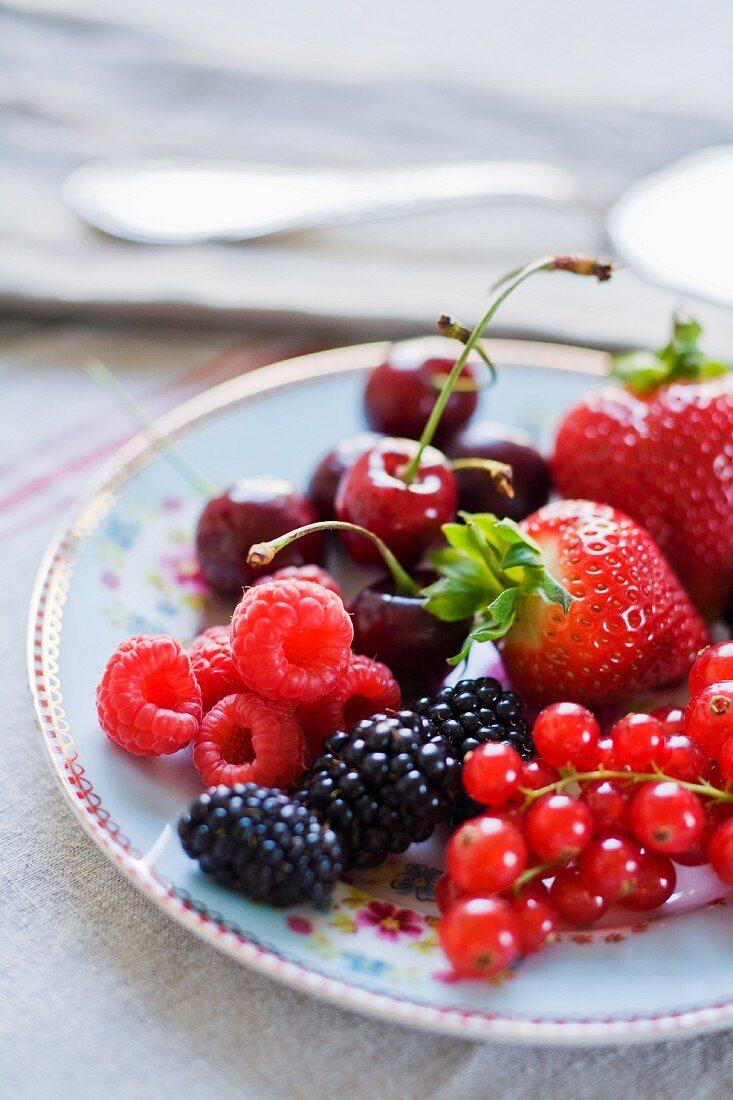 Fresh berries and cherries on a plate