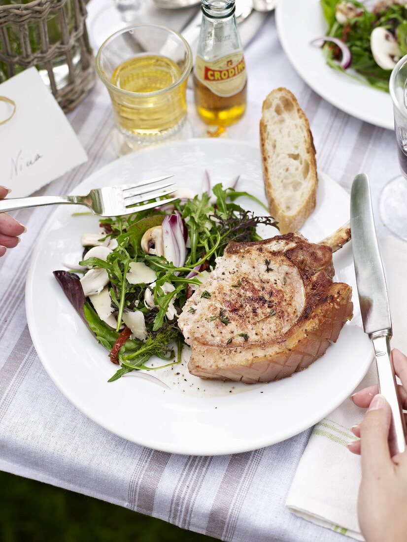 Grilled pork chop filled with herb cream cheese