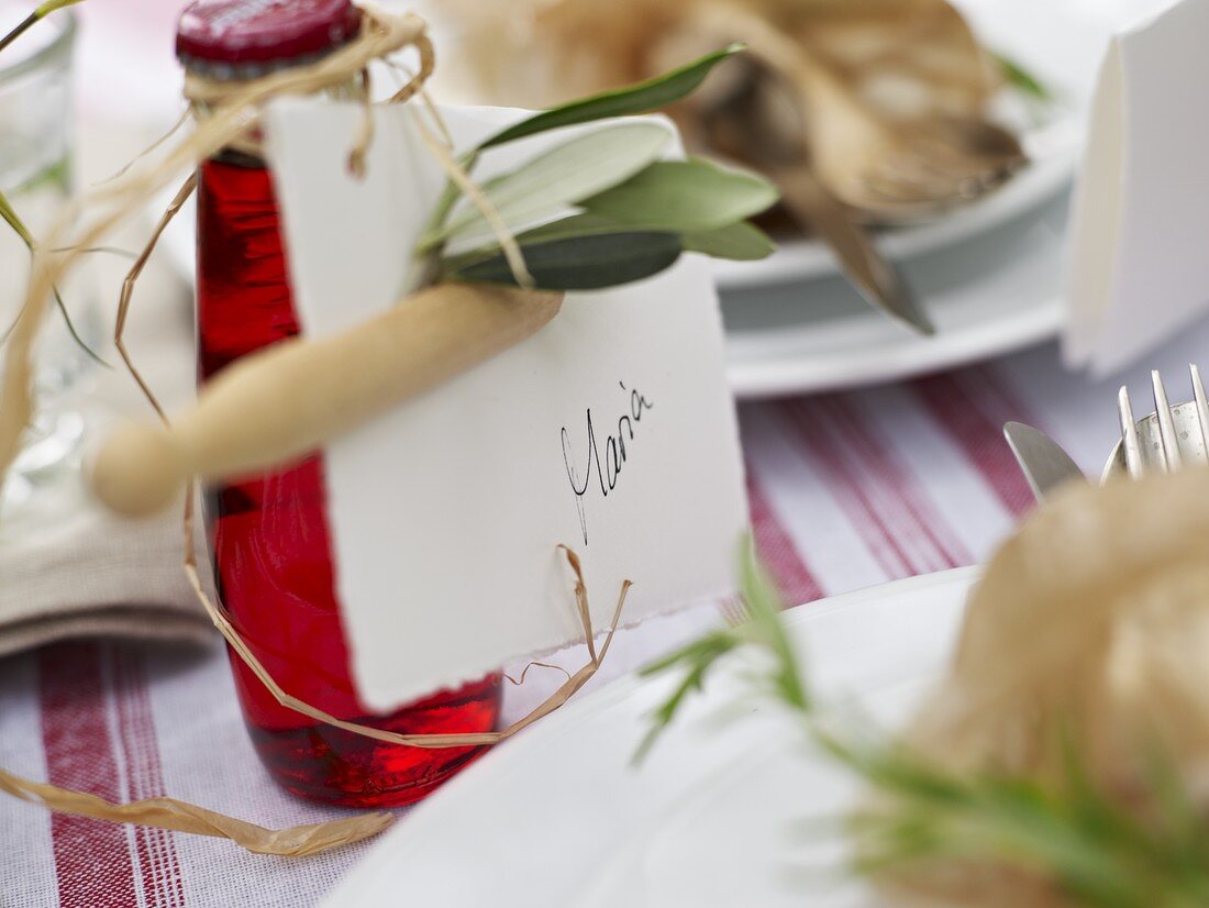 A place card tied around the neck of a bottle