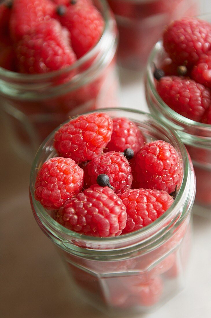 Rasberries and spices in preserving jars