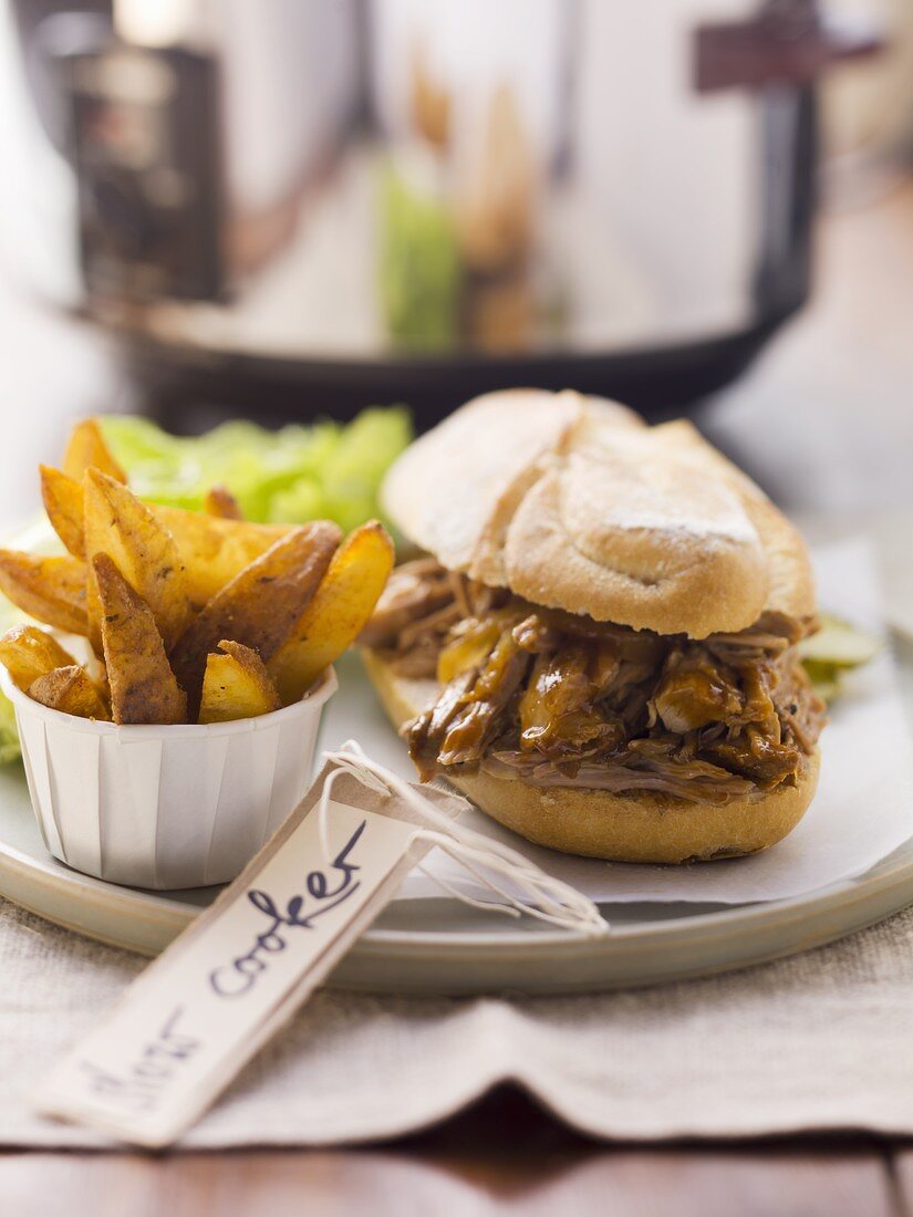 Pulled pork sandwich and potato wedges