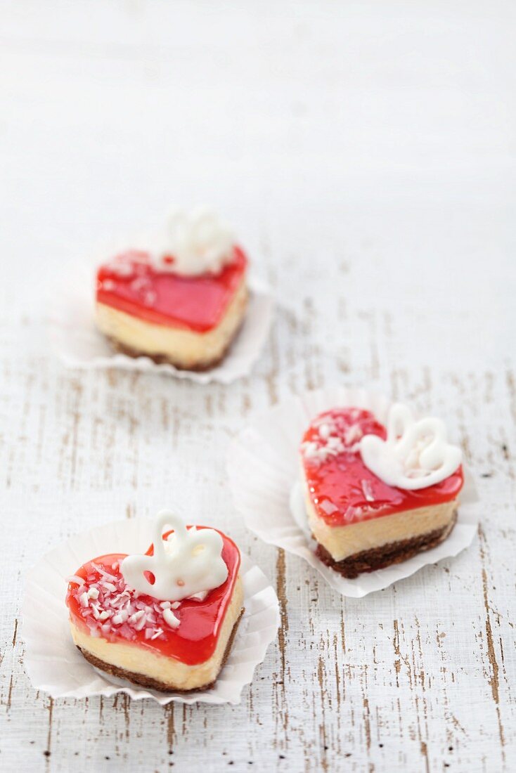 Three heart-shaped cakes with a cream filling and a red jelly topping