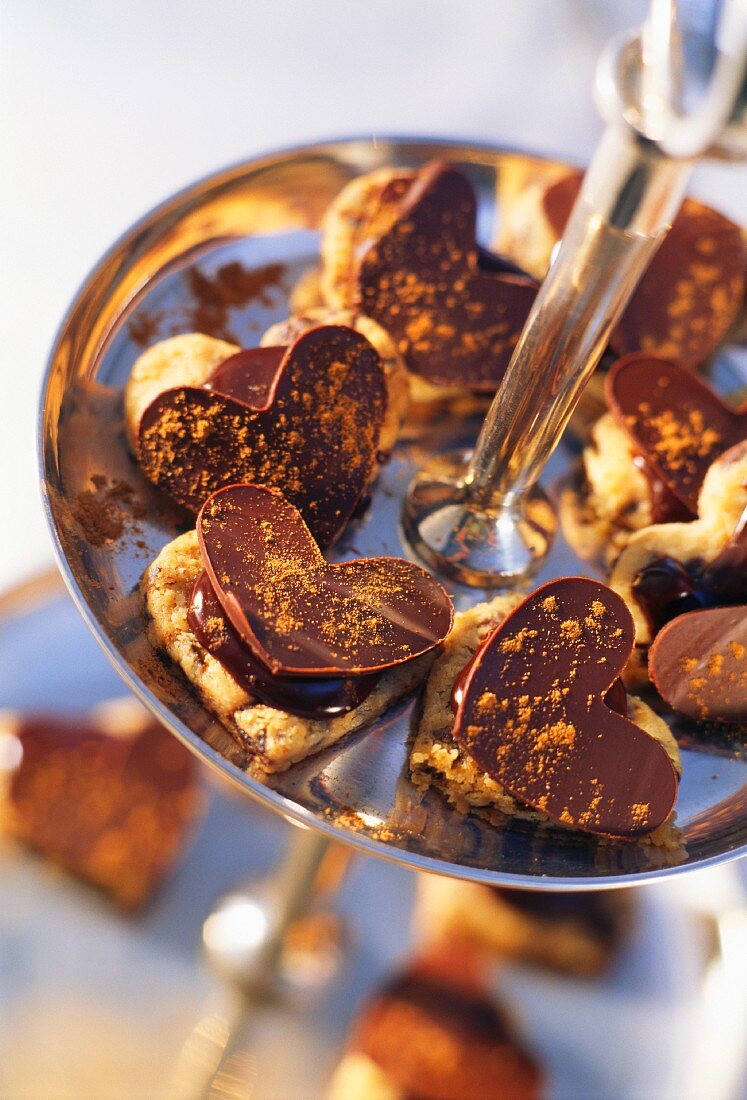 Heart-shaped chocolate biscuits on a cake stand